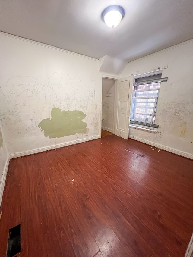 unfurnished room with lofted ceiling and hardwood / wood-style floors