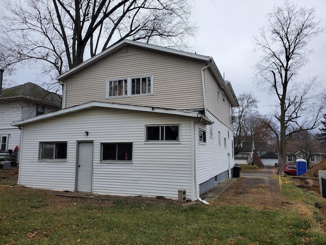 back of property featuring a lawn