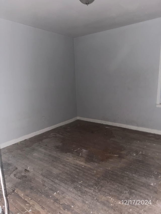 spare room with dark wood-type flooring