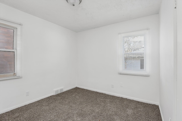 19723 Carrie St, Detroit, MI 48234 - unfurnished room with dark colored carpet and baseboards