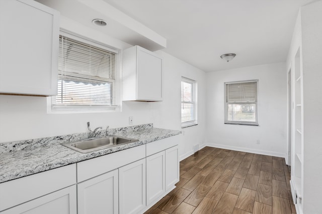 19723 Carrie St, Detroit, MI 48234 - kitchen with white cabinets and wood finished floors