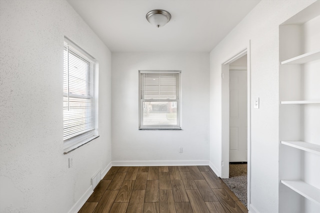 19723 Carrie St, Detroit, MI 48234 - spare room featuring dark wood-type flooring and baseboards