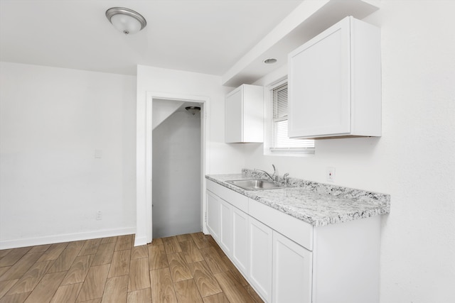 19723 Carrie St, Detroit, MI 48234 - kitchen with light countertops, light wood finished floors, and white cabinetry