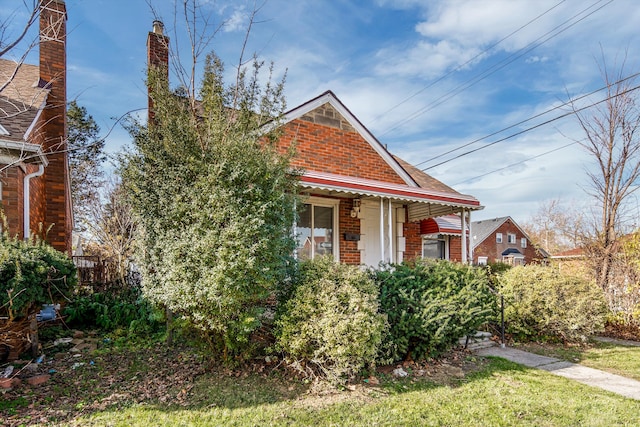 19723 Carrie St, Detroit, MI 48234 - view of front facade with brick siding and a chimney