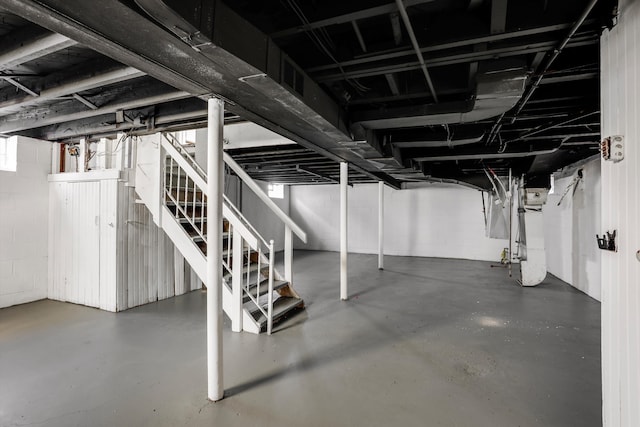 19723 Carrie St, Detroit, MI 48234 - basement with stairs, concrete block wall, and heating unit
