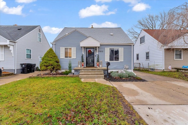 bungalow-style home with a front lawn