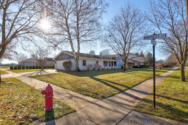 ranch-style house with a garage and a front yard