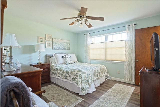 bedroom with dark wood-type flooring and ceiling fan