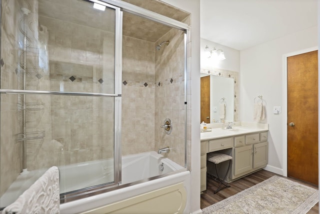 bathroom featuring vanity, shower / bath combination with glass door, and hardwood / wood-style floors