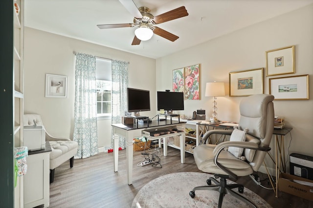 office area with light hardwood / wood-style floors and ceiling fan