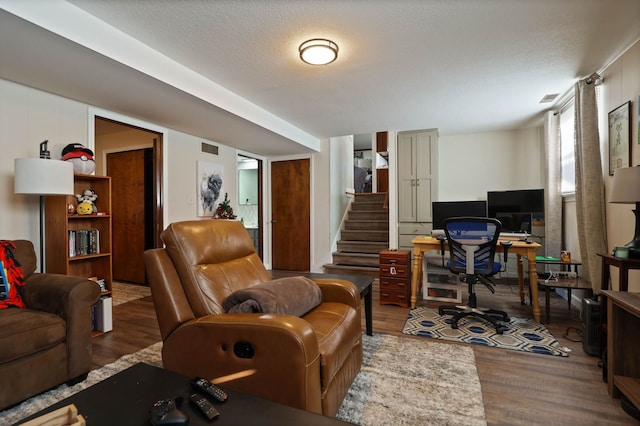 home office featuring hardwood / wood-style flooring and a textured ceiling