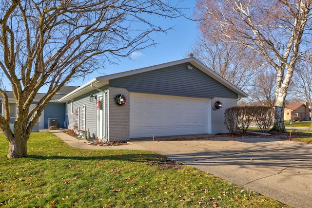 view of property exterior with a garage and a lawn