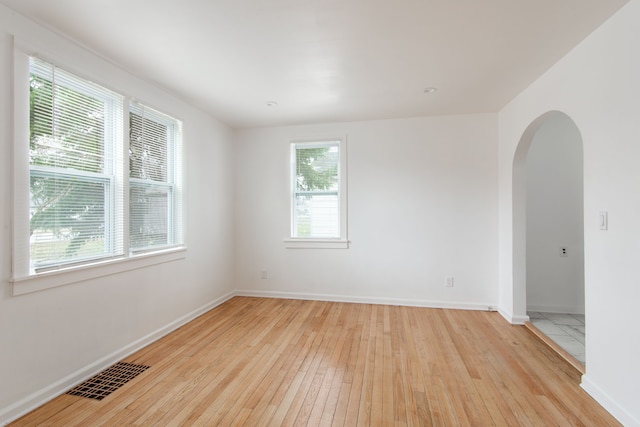 unfurnished room with plenty of natural light and light wood-type flooring