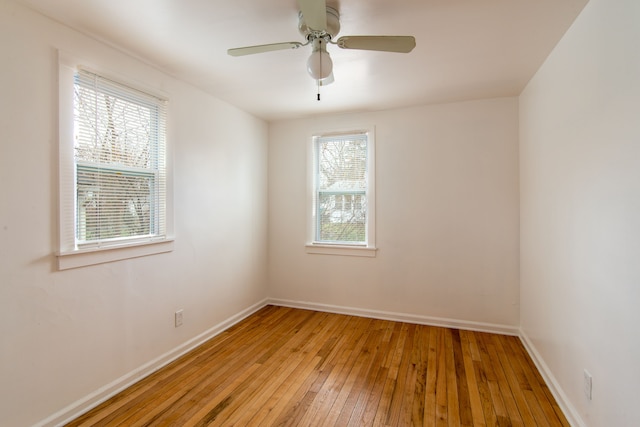 spare room with ceiling fan, light hardwood / wood-style flooring, and a healthy amount of sunlight