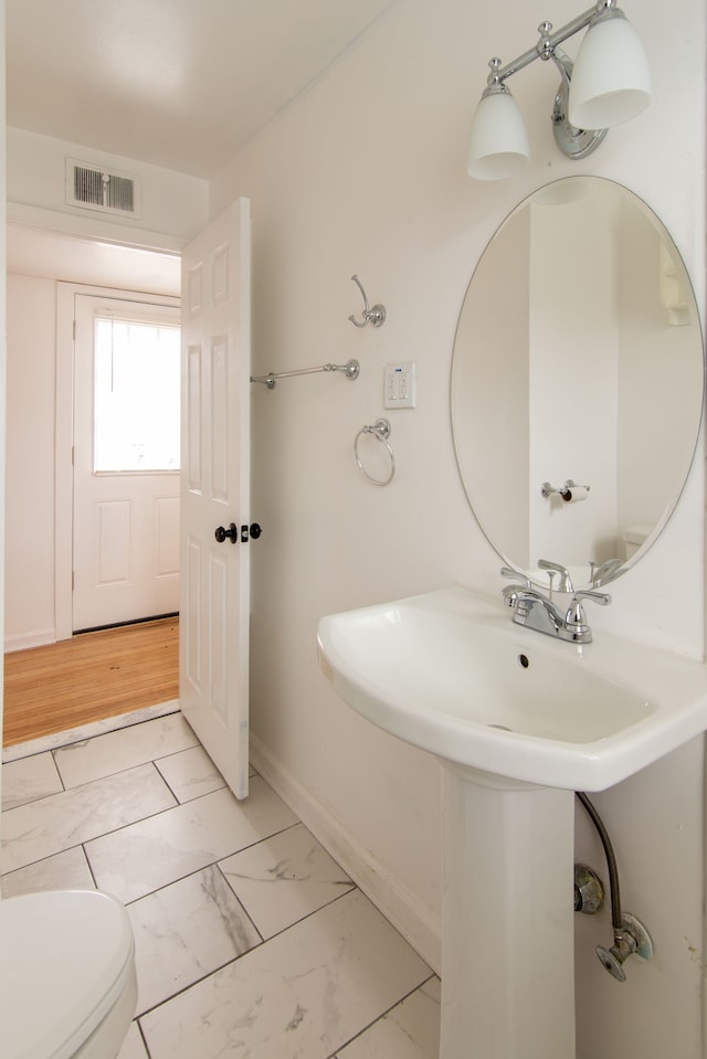 bathroom featuring sink and toilet