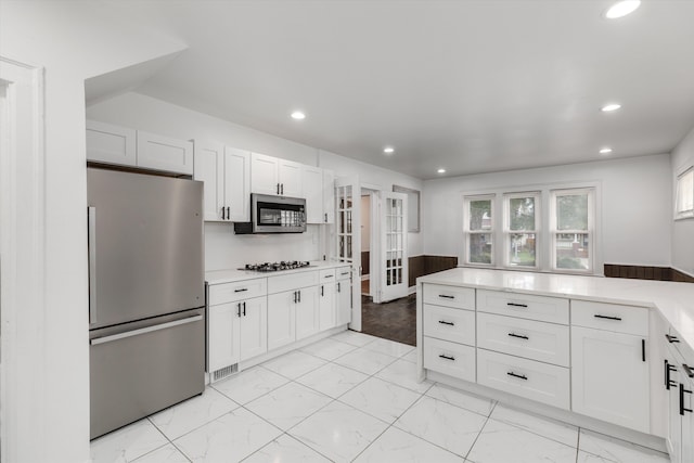 kitchen with white cabinetry and stainless steel appliances