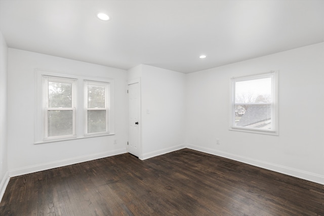 empty room featuring dark hardwood / wood-style flooring