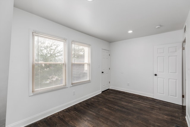 spare room with dark wood-type flooring