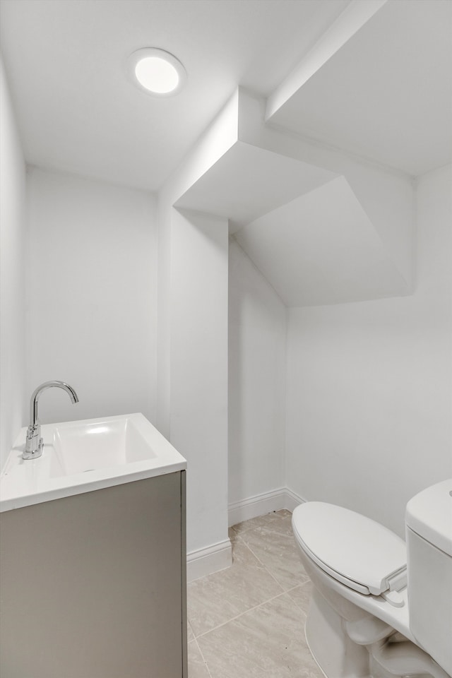 bathroom featuring tile patterned floors, vanity, and toilet