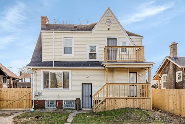 back of property featuring a balcony