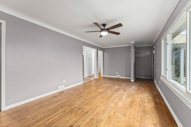 empty room with ceiling fan and light hardwood / wood-style floors