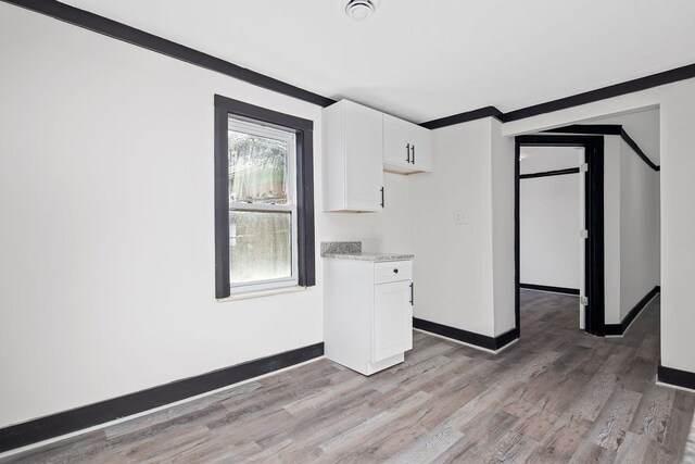 empty room featuring crown molding and hardwood / wood-style floors