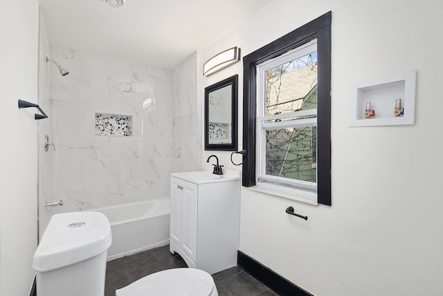 full bathroom with tile patterned flooring, vanity, toilet, and tiled shower / bath combo