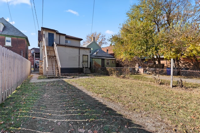 rear view of property featuring a lawn