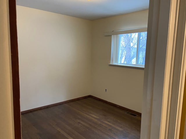 empty room featuring dark hardwood / wood-style flooring