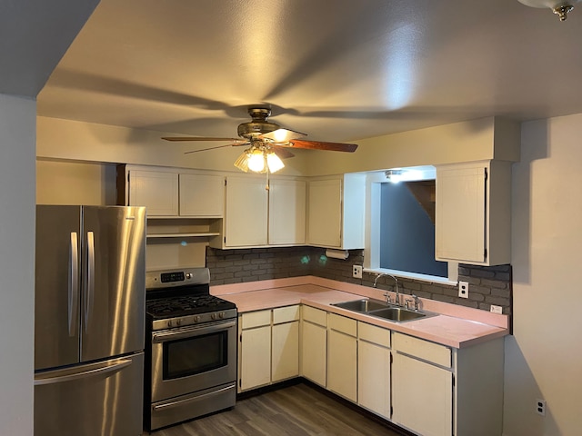 kitchen with ceiling fan, sink, dark wood-type flooring, tasteful backsplash, and appliances with stainless steel finishes