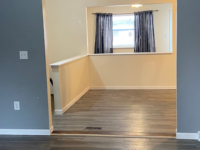 empty room featuring dark wood-type flooring