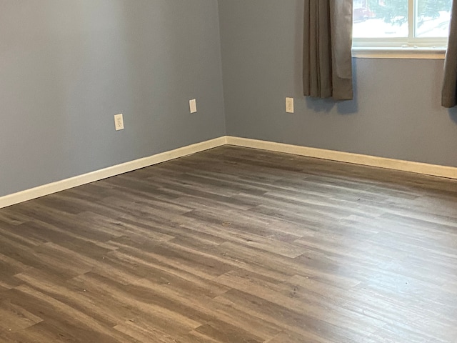 spare room with dark wood-type flooring