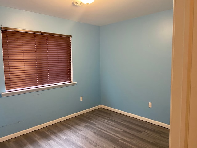 empty room with hardwood / wood-style flooring