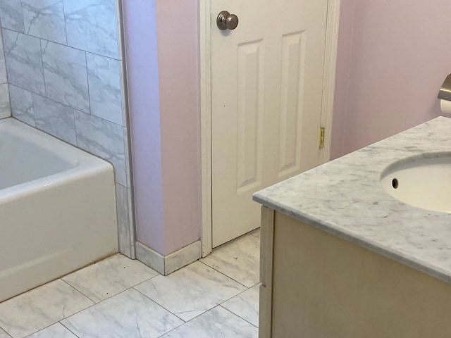 bathroom with a tub to relax in and vanity