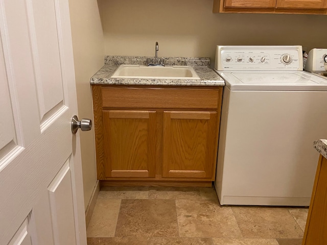 laundry room with cabinets, washer / dryer, and sink