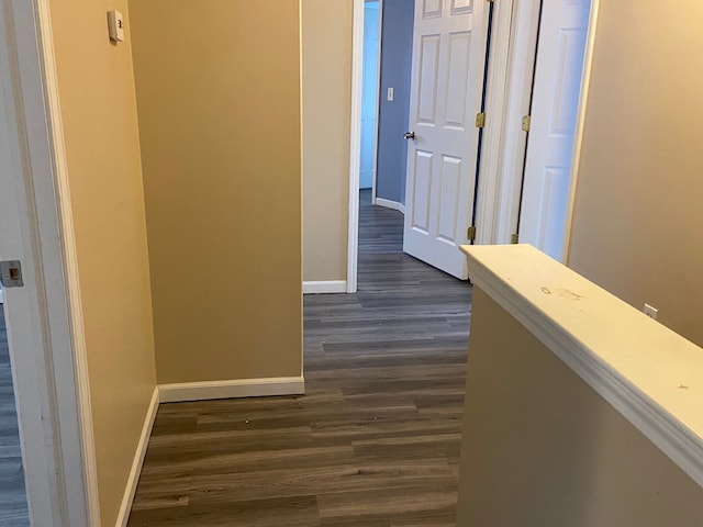 hallway with dark hardwood / wood-style floors