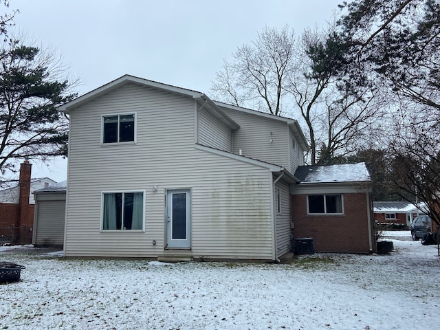 view of snow covered rear of property