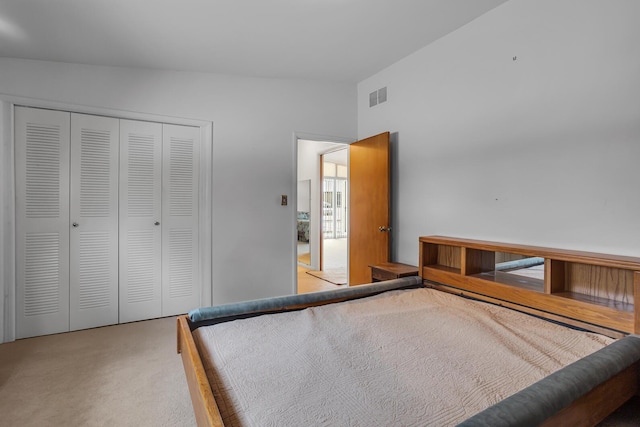 unfurnished bedroom featuring carpet flooring, a closet, and vaulted ceiling