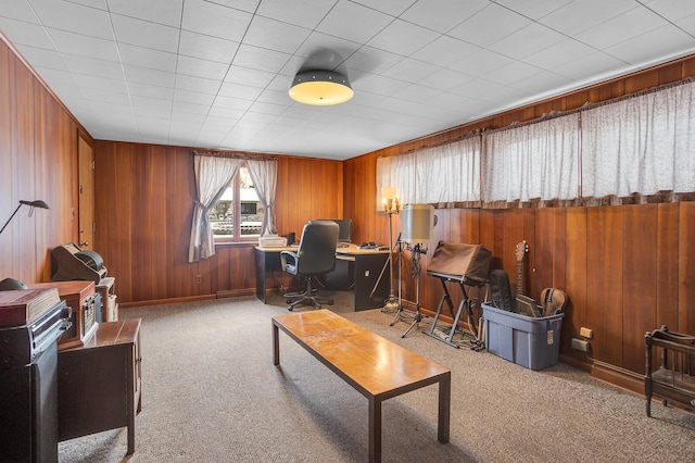 office area featuring carpet flooring and wooden walls