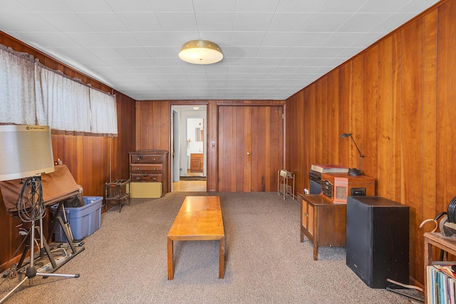 carpeted office featuring wooden walls