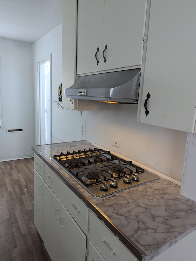 kitchen featuring white cabinetry, dark wood-type flooring, and stainless steel gas cooktop