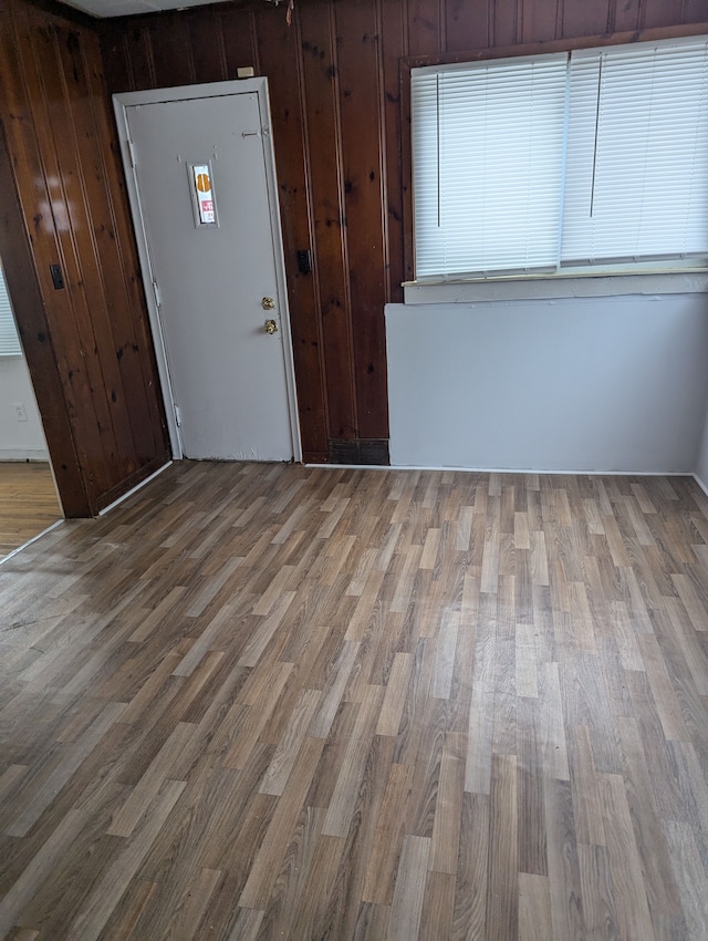 entryway with hardwood / wood-style flooring and wood walls