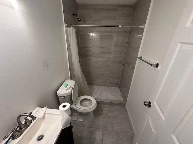 bathroom with a shower with curtain, tile patterned flooring, vanity, and toilet