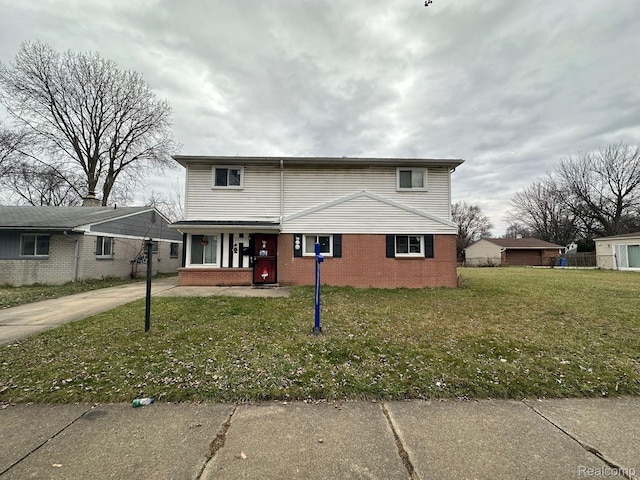 26202 Colgate St, Inkster, MI 48141 - traditional-style house with a porch, brick siding, a front yard, and driveway