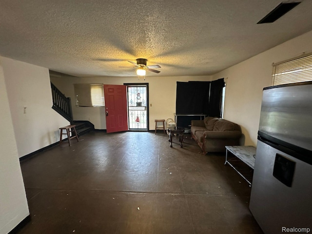26202 Colgate St, Inkster, MI 48141 - living area with stairs, ceiling fan, concrete floors, and a textured ceiling