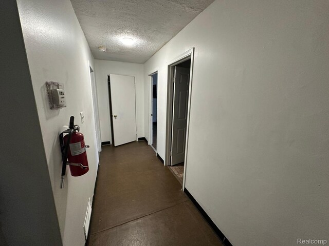 26202 Colgate St, Inkster, MI 48141 - corridor with a textured ceiling and concrete flooring