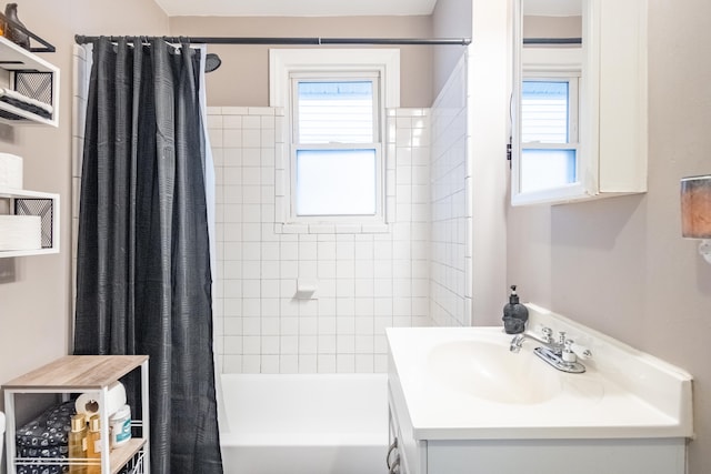 bathroom with shower / tub combo and vanity