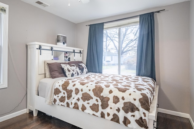 bedroom featuring ceiling fan and dark hardwood / wood-style flooring