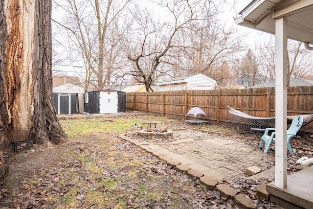 view of yard featuring a storage shed and a patio area