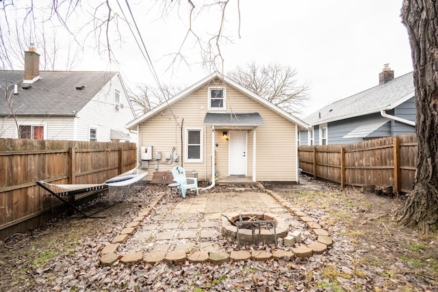 back of property featuring an outdoor fire pit and a patio area